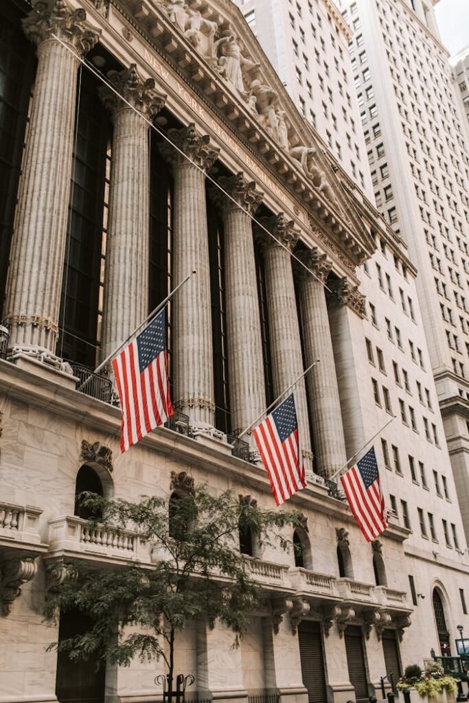 Iconic New York Stock Exchange with American flags on Wall Street, USA.